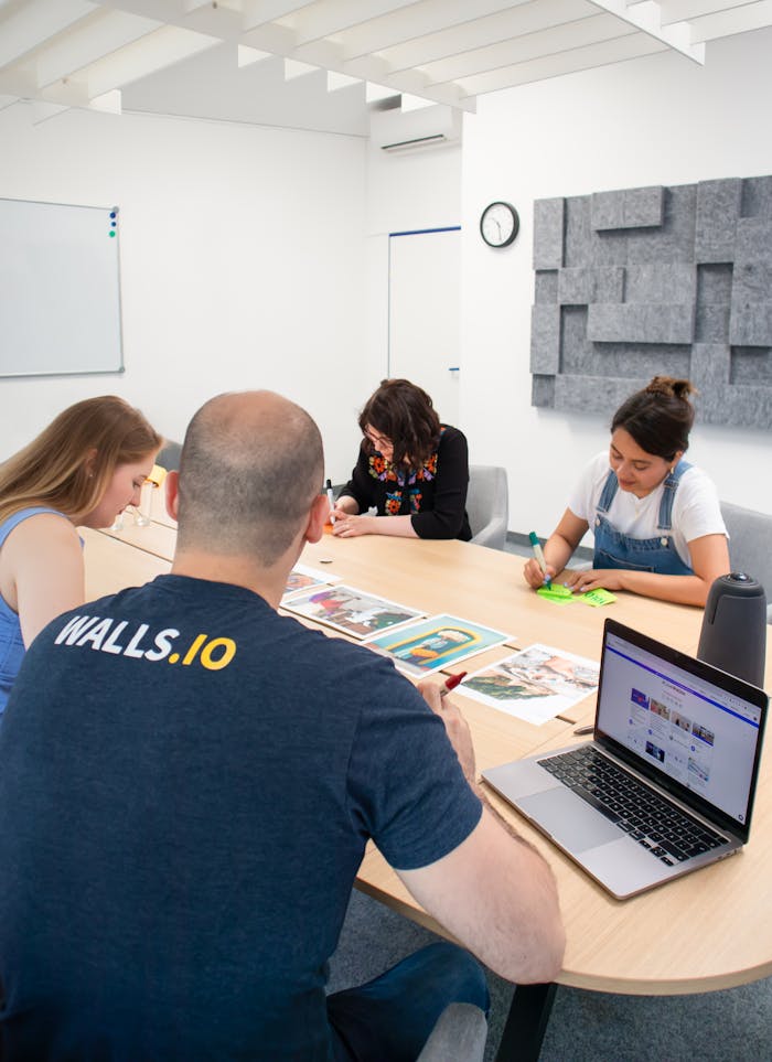 A diverse group of professionals collaborate in a modern office setting, working on marketing strategies.